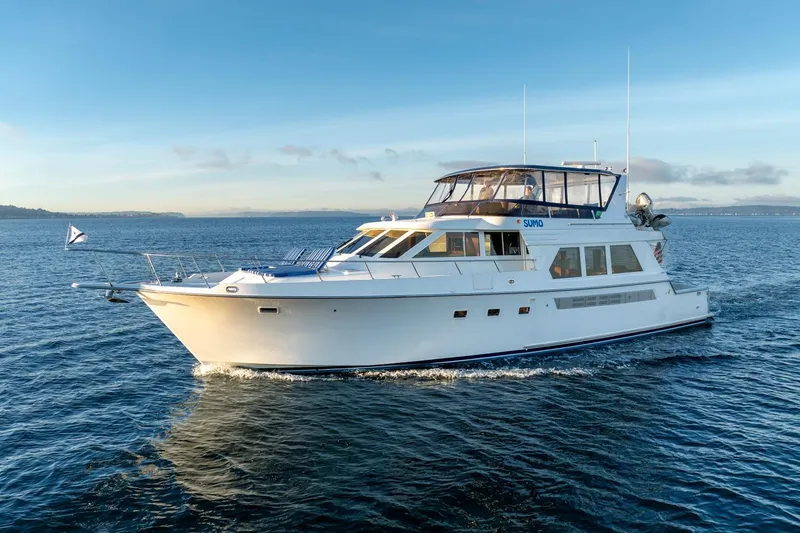 Sumo Yacht Photos Pics 1991 Tollycraft 57 Pilothouse Motor Yacht cruising on open water under clear skies.