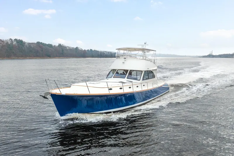 Sapphire II Yacht Photos Pics 2006 Hinckley Talaria 55 FB cruising on a calm river.