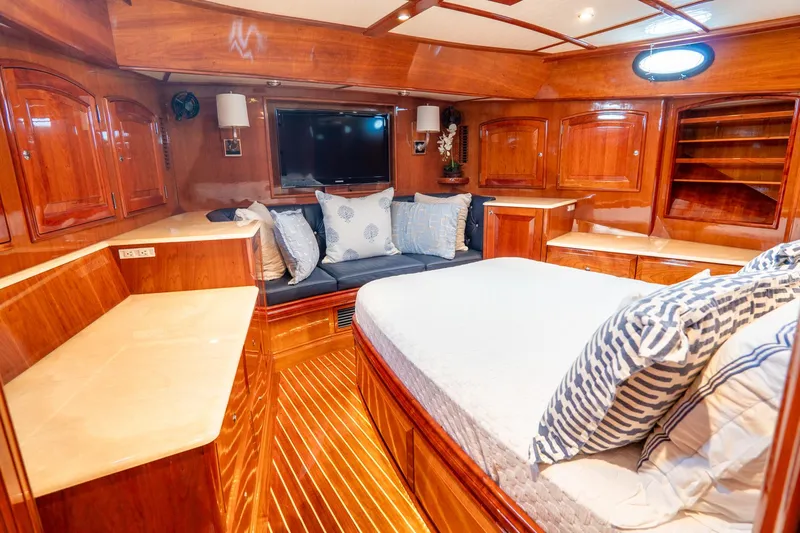 Sapphire II Yacht Photos Pics Luxurious cabin interior of 2006 Hinckley Talaria 55 FB yacht with wood finishes and cozy bedding.