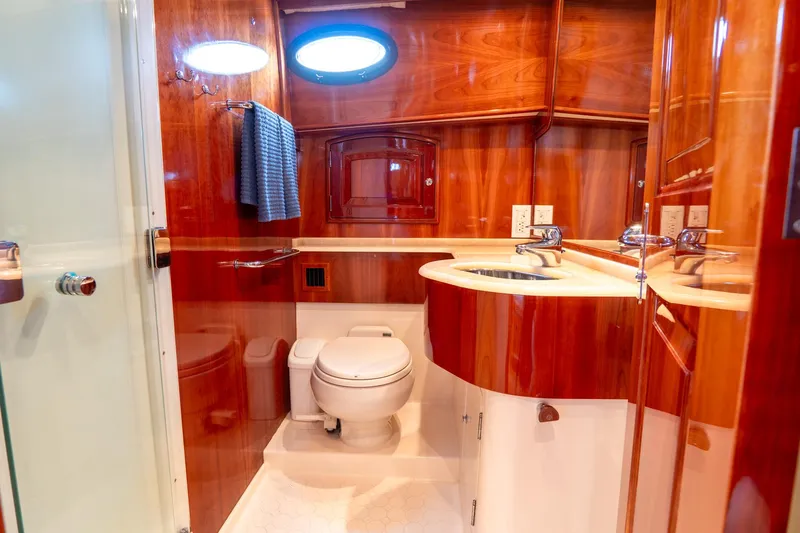 Sapphire II Yacht Photos Pics Luxurious 2006 Hinckley Talaria 55 FB yacht bathroom with wood finish and modern fixtures.