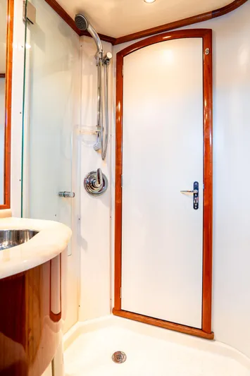 Sapphire II Yacht Photos Pics Luxurious 2006 Hinckley Talaria 55 FB yacht bathroom with elegant wood trim and modern shower.