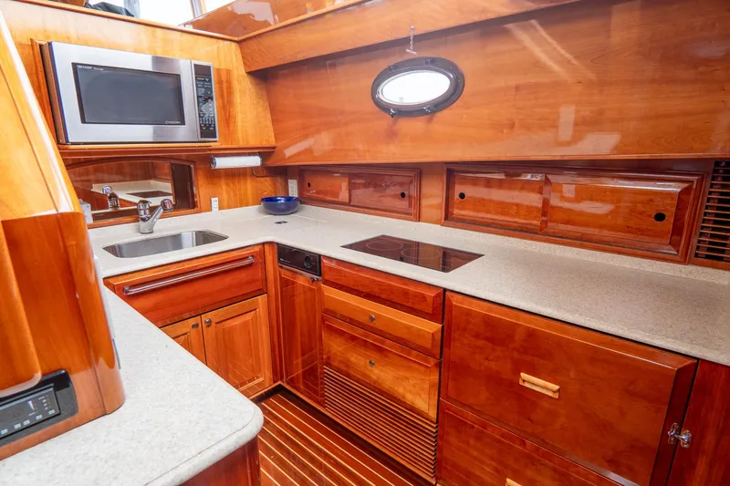 Sapphire II Yacht Photos Pics Luxurious 2006 Hinckley Talaria 55 FB yacht kitchen with wood cabinetry and modern appliances.