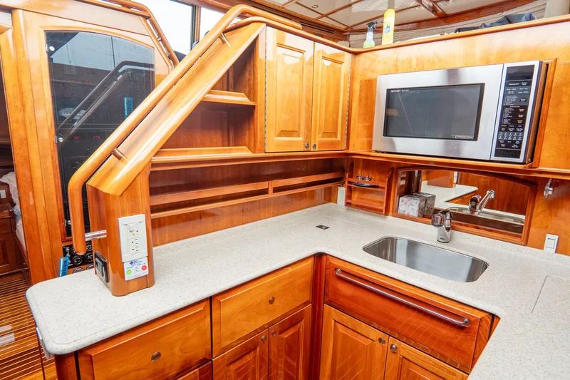 Sapphire II Yacht Photos Pics Luxurious 2006 Hinckley Talaria 55 FB yacht kitchen with wood cabinetry and modern appliances.