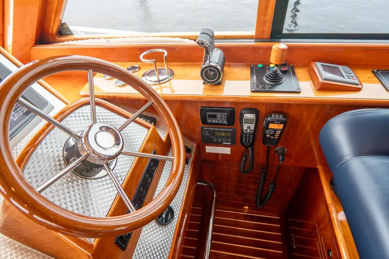 Sapphire II Yacht Photos Pics Hinckley Talaria 55 FB 2006 yacht helm with wooden steering wheel and navigation controls.