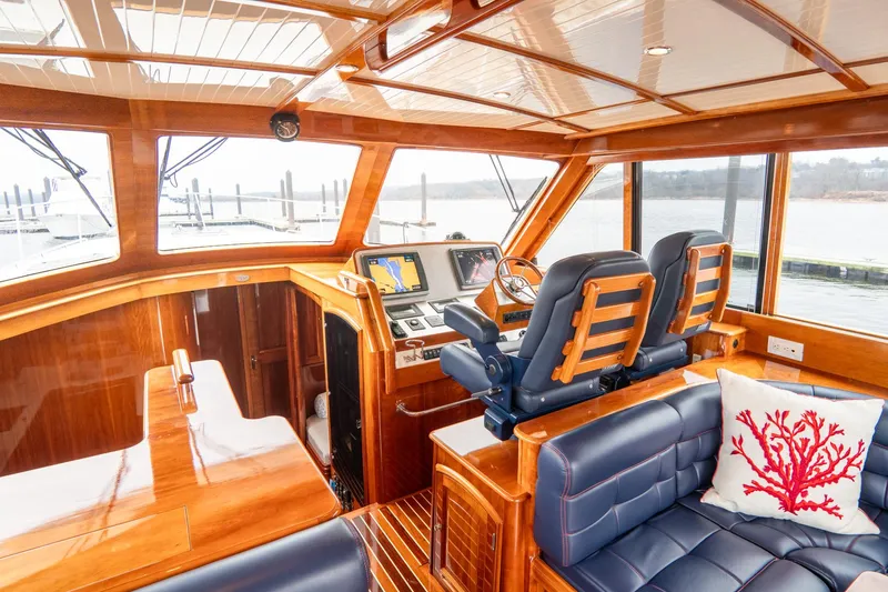 Sapphire II Yacht Photos Pics Luxurious 2006 Hinckley Talaria 55 FB yacht interior with plush seating and navigation controls.