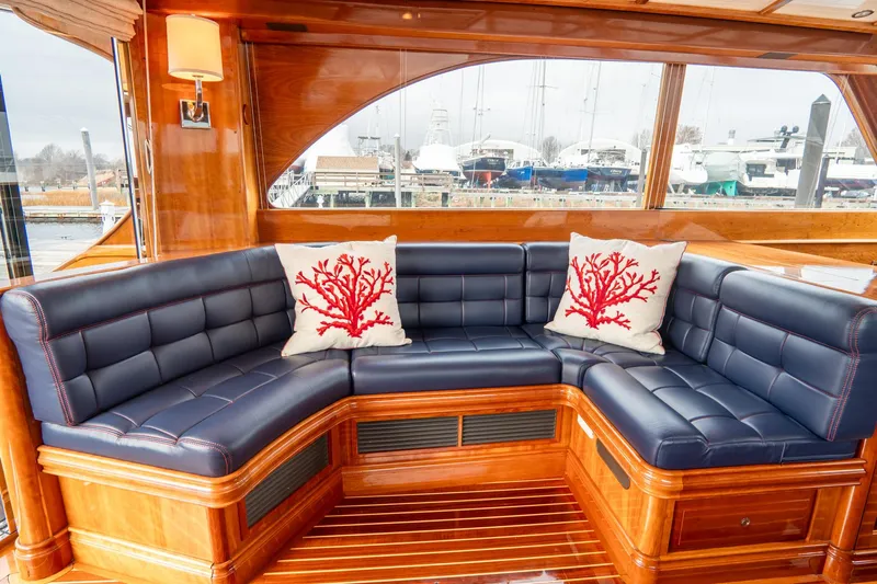 Sapphire II Yacht Photos Pics Luxurious 2006 Hinckley Talaria 55 FB yacht interior with navy seating and coral-themed pillows.