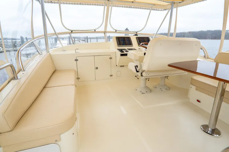 Sapphire II Yacht Photos Pics Interior view of 2006 Hinckley Talaria 55 FB yacht with beige seating and helm.