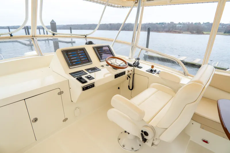 Sapphire II Yacht Photos Pics Hinckley Talaria 55 FB 2006 yacht helm with navigation controls and leather captain's chair.