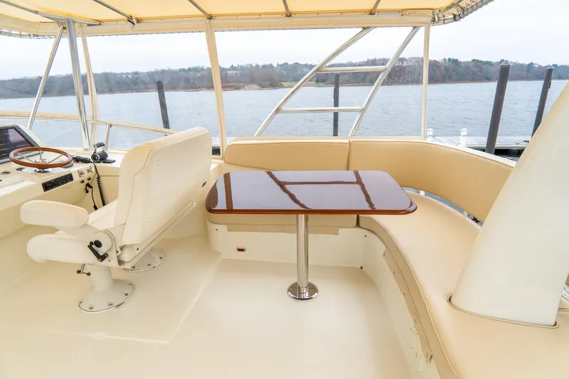 Sapphire II Yacht Photos Pics 2006 Hinckley Talaria 55 FB yacht interior with seating and table, overlooking water.
