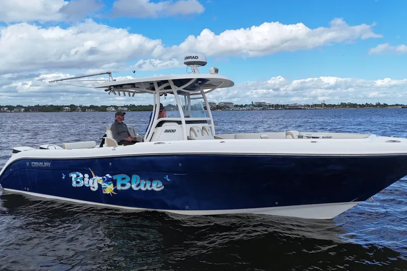 Big Blue Yacht Photos Pics 2017 Century 3200 Center Console boat named "Big Blue" on the water under a blue sky.