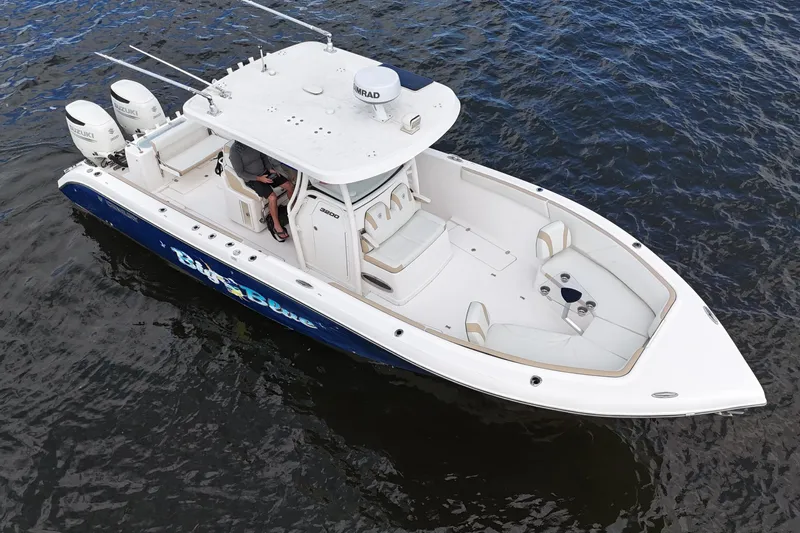 Big Blue Yacht Photos Pics 2017 Century 3200 Center Console boat on water, featuring dual engines and spacious seating.