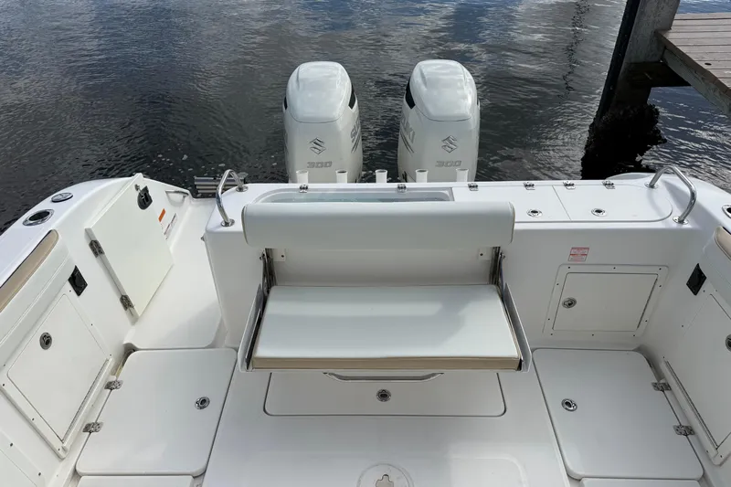 Big Blue Yacht Photos Pics 2017 Century 3200 Center Console boat with dual Suzuki 300 engines, docked on calm water.