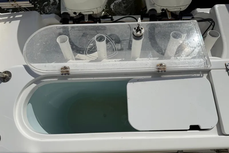 Big Blue Yacht Photos Pics Livewell on a 2017 Century 3200 Center Console boat, featuring a clear lid and rod holders.