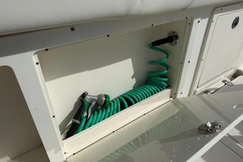 Big Blue Yacht Photos Pics Storage compartment with green hose on a 2017 Century 3200 Center Console boat.