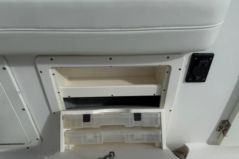 Big Blue Yacht Photos Pics 2017 Century 3200 Center Console storage compartment with tackle boxes and utility outlet.