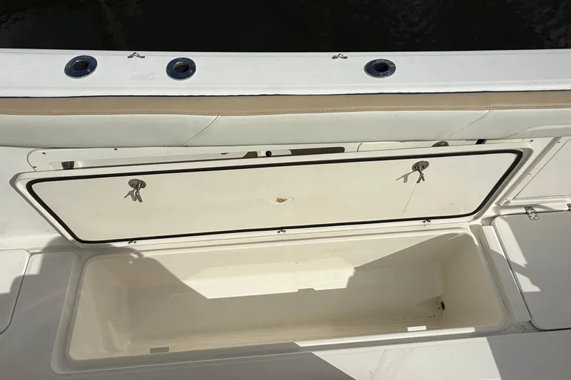 Big Blue Yacht Photos Pics 2017 Century 3200 Center Console boat storage compartment with open hatch and keys.