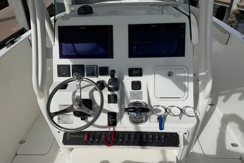 Big Blue Yacht Photos Pics Century 3200 Center Console 2017 dashboard with steering wheel and navigation controls.