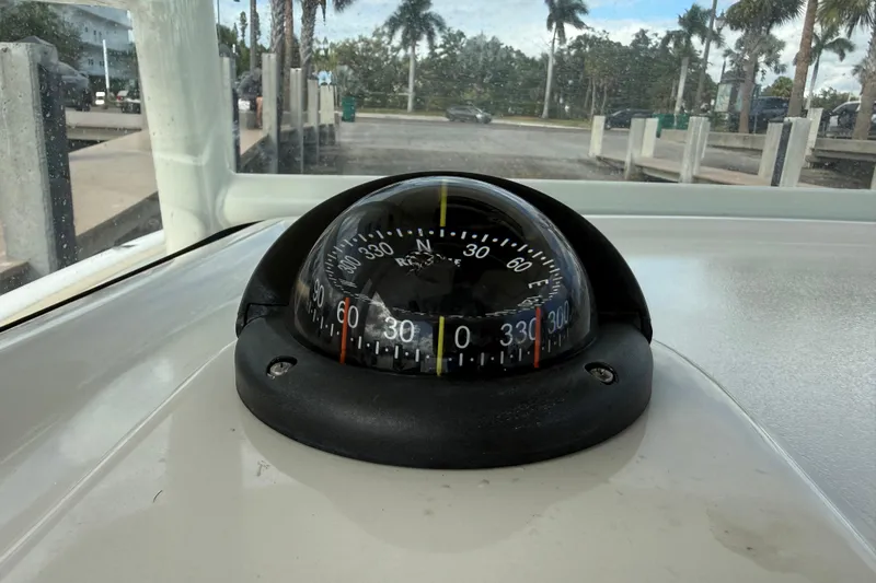 Big Blue Yacht Photos Pics Compass on 2017 Century 3200 Center Console boat, docked with palm trees in background.