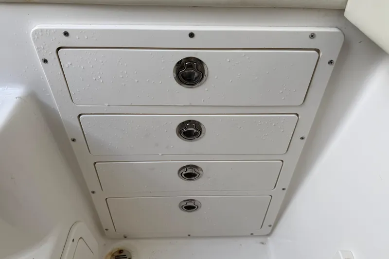 Big Blue Yacht Photos Pics Storage compartments on a 2017 Century 3200 Center Console boat, featuring four secure latches.