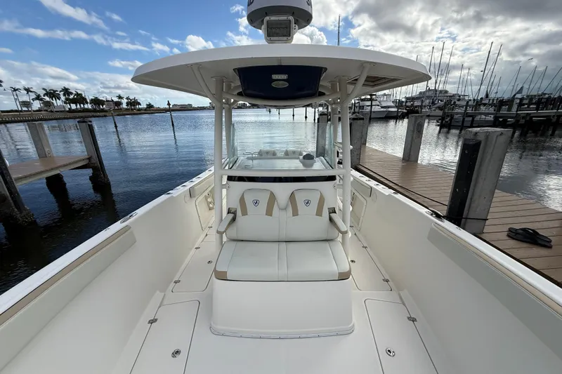 Big Blue Yacht Photos Pics 2017 Century 3200 Center Console boat docked at marina, clear sky, calm water.