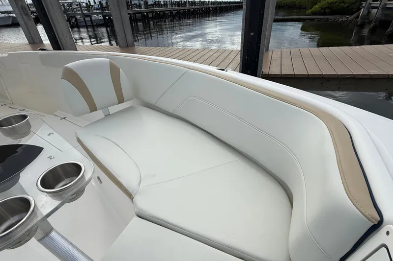 Big Blue Yacht Photos Pics 2017 Century 3200 Center Console boat with white seating and cup holders at a dock.