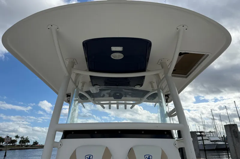 Big Blue Yacht Photos Pics 2017 Century 3200 Center Console boat with T-top, docked under cloudy sky.