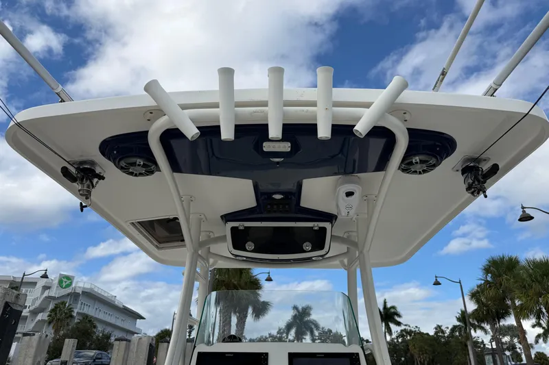 Big Blue Yacht Photos Pics 2017 Century 3200 Center Console boat with rod holders and speakers under a blue sky.