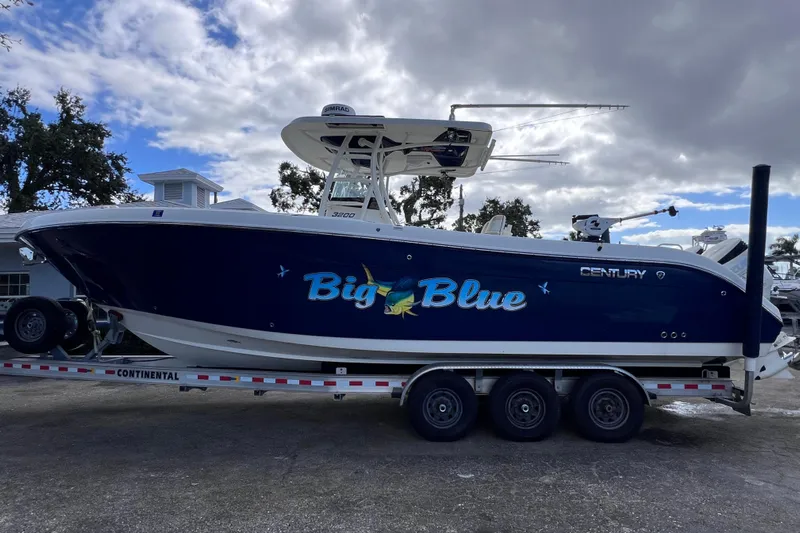 Big Blue Yacht Photos Pics 2017 Century 3200 Center Console boat named "Big Blue" on a trailer under cloudy sky.