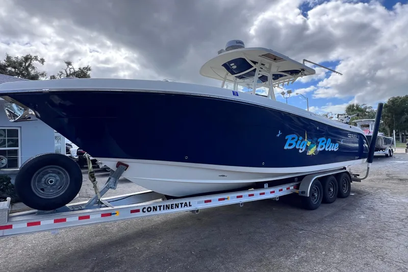 Big Blue Yacht Photos Pics 2017 Century 3200 Center Console boat named "Big Blue" on a trailer under cloudy skies.