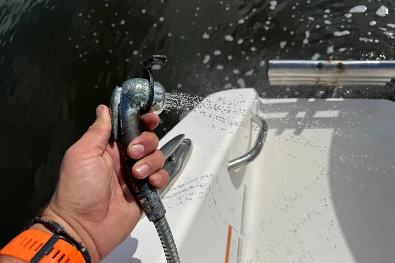 Big Blue Yacht Photos Pics Hand holding a spray nozzle on a 2017 Century 3200 Center Console boat.