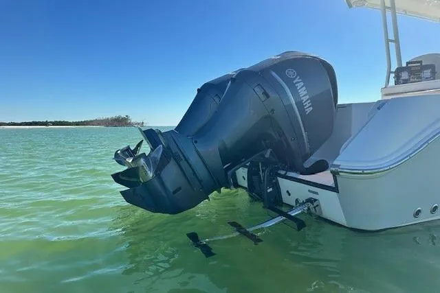  Yacht Photos Pics Edgewater 320CC 2015 boat with Yamaha outboard motor in calm green water.