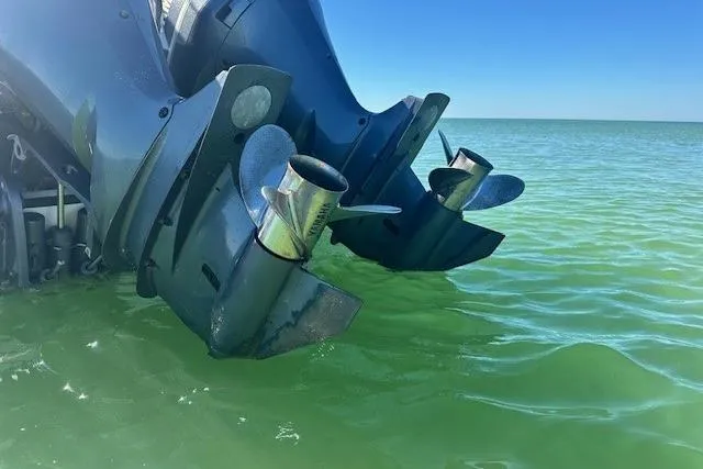  Yacht Photos Pics Twin outboard motors on a 2015 Edgewater 320CC in clear green water.