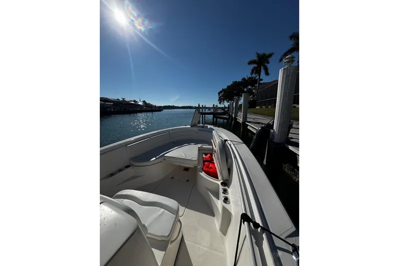  Yacht Photos Pics 2015 Edgewater 320CC boat docked under sunny skies with palm trees.
