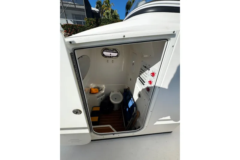  Yacht Photos Pics Interior view of 2015 Edgewater 320CC boat cabin with toilet and control panel.