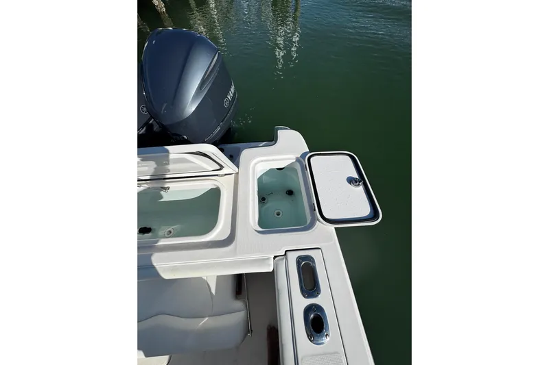 Yacht Photos Pics 2015 Edgewater 320CC boat with open storage compartments and Yamaha outboard motor.