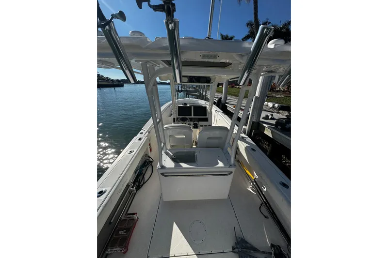  Yacht Photos Pics 2015 Edgewater 320CC boat interior with helm, docked by the water.