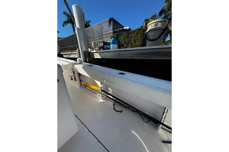  Yacht Photos Pics 2015 Edgewater 320CC boat interior with fishing rod storage and dockside view.