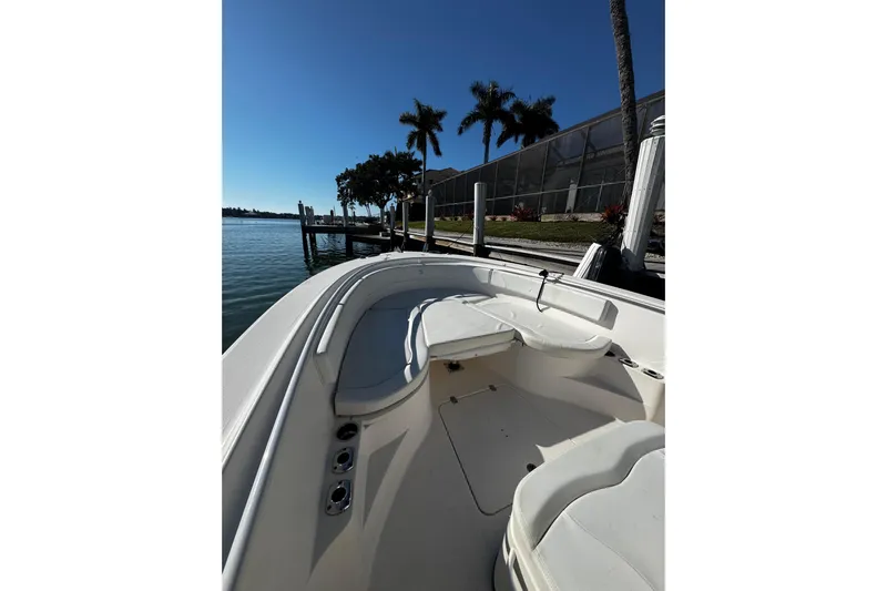  Yacht Photos Pics 2015 Edgewater 320CC boat docked by palm trees and waterfront.
