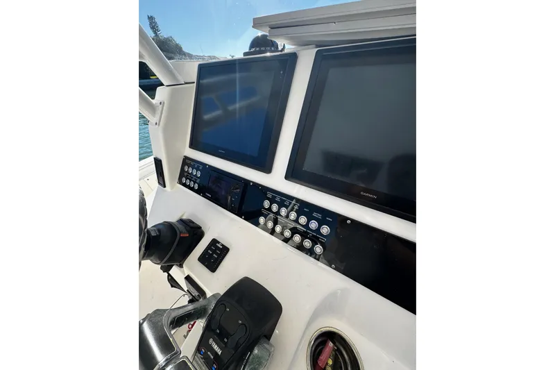  Yacht Photos Pics Control panel of 2015 Edgewater 320CC boat with dual Garmin screens and Yamaha controls.