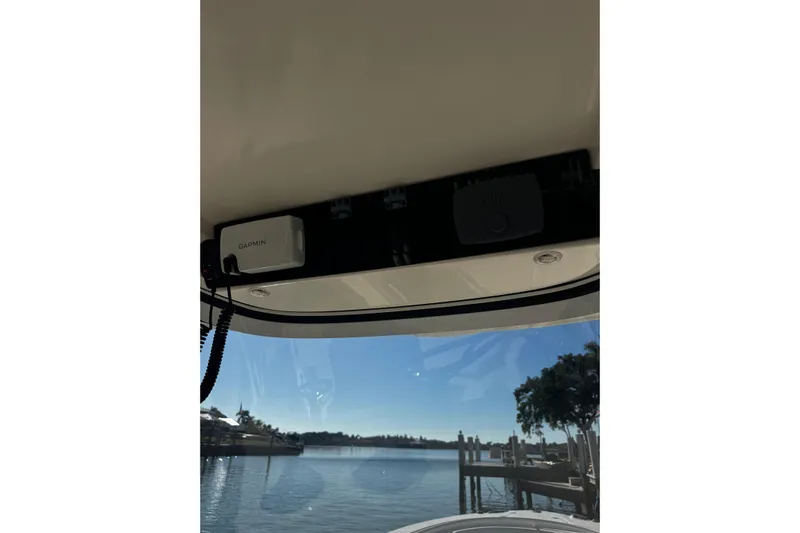 Yacht Photos Pics 2015 Edgewater 320CC boat interior with Garmin device, overlooking a serene waterfront.