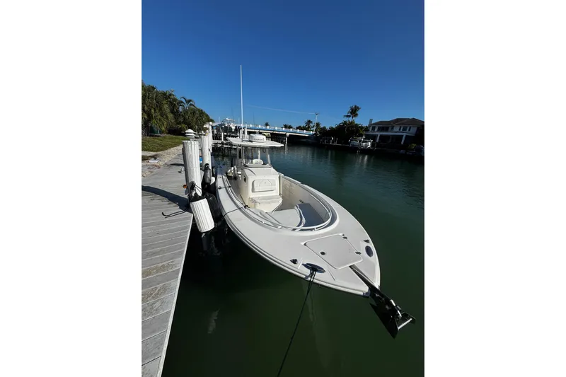  Yacht Photos Pics 2015 Edgewater 320CC boat docked in a serene waterfront setting.