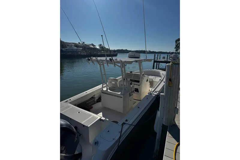  Yacht Photos Pics 2015 Edgewater 320CC boat docked by a serene waterfront.