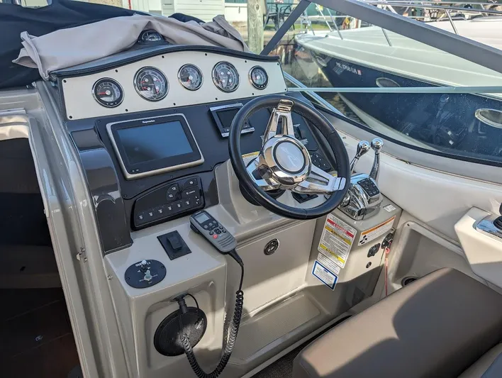 So Lucky Yacht Photos Pics 2015 Sea Ray 330 Sundancer helm with steering wheel, gauges, and navigation controls.