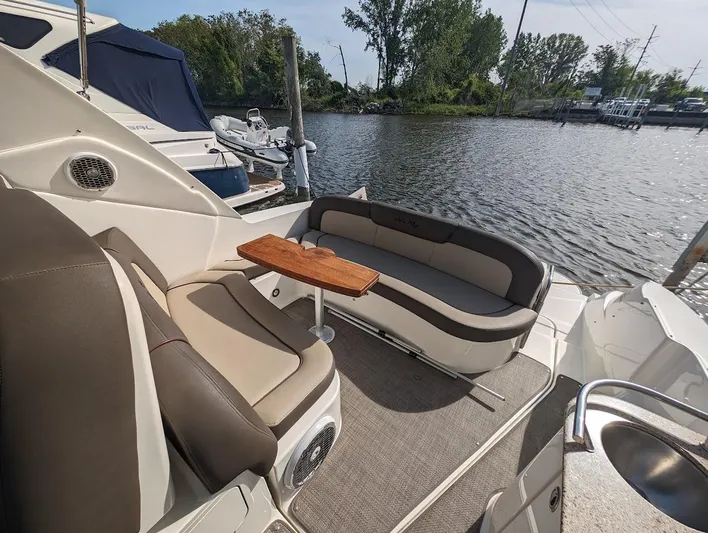 So Lucky Yacht Photos Pics 2015 Sea Ray 330 Sundancer boat interior with seating area and table by the water.