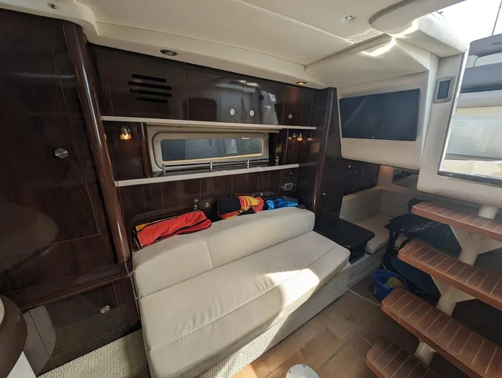So Lucky Yacht Photos Pics Interior of 2015 Sea Ray 330 Sundancer with sofa, storage, and TV.