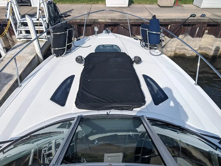 So Lucky Yacht Photos Pics 2015 Sea Ray 330 Sundancer docked, bow view with sunpad and hatches.