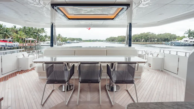 Pinch Me Yacht Photos Pics Luxurious Ocean Alexander 28R yacht deck with elegant seating and scenic waterfront view.