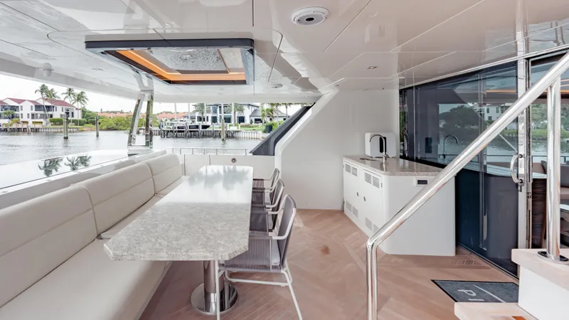 Pinch Me Yacht Photos Pics Luxurious Ocean Alexander 28R yacht interior with elegant dining area, modern design, and waterfront view.