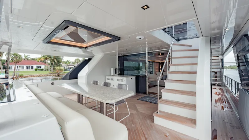 Pinch Me Yacht Photos Pics Luxurious 2021 Ocean Alexander 28R yacht interior with elegant dining area and staircase.