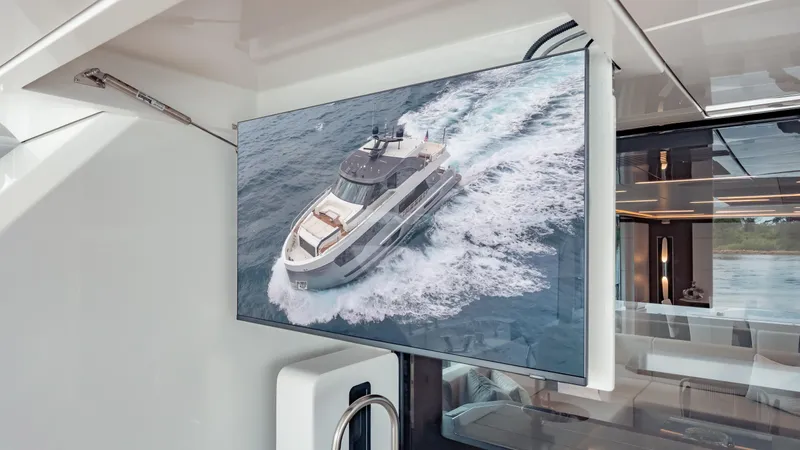Pinch Me Yacht Photos Pics Interior view of 2021 Ocean Alexander 28R yacht with a screen displaying the yacht at sea.